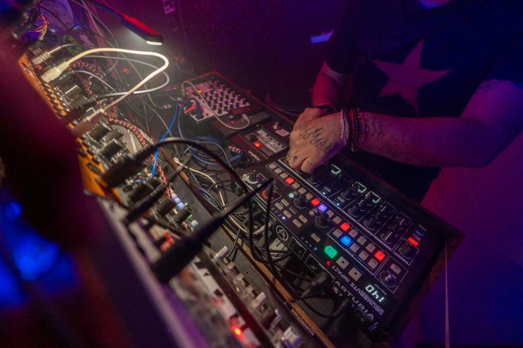 view of a dj using a mixer at a nightclub